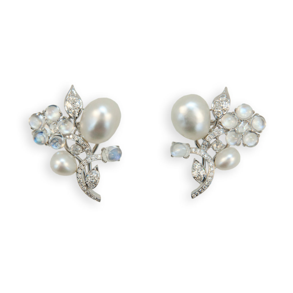 Exquisite Keshi pearl, moonstone and diamond earrings.18k white gold earrings each set with (2) Keshi Pearls (4)=5.32 grams (6) round & oval Moonstones (12)=6.33 carats total weight. (2) Rose cut Diamonds (4)=.76carat total weight. and (28) round Diamonds (56)=.88 carat total weight. Impeccably crafted using beautiful blue hued moonstones, lustrous Keshi pearls and white diamonds.