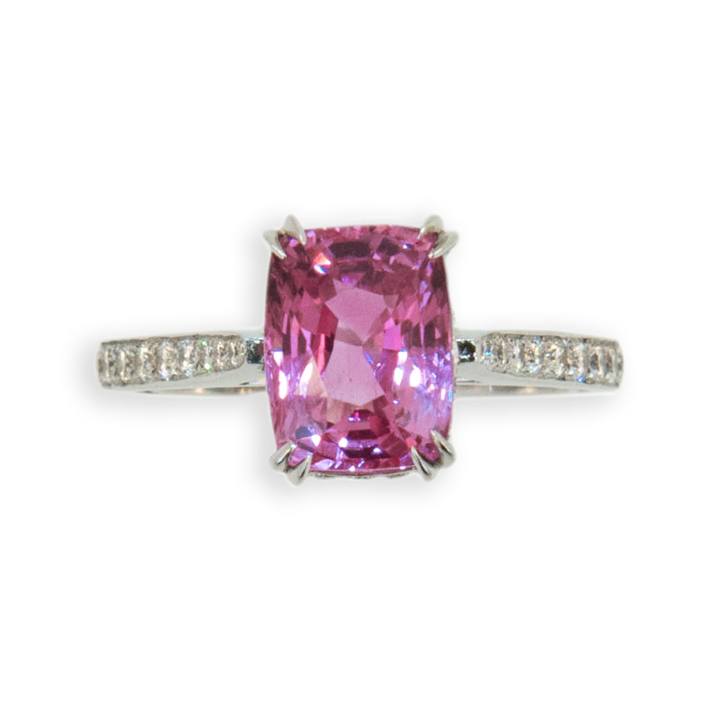 Delicious candy colored pink sapphire ring. Set in 18k white gold and diamonds. Set in center is one 3.53ct. rectangular cushion cut Pink Sapphire. Shank and underbezel are set with 48 round Diamonds .8 to 1.6mm weighing .37ct.twt. Tapered split prongs. Size is 6.5 with sizing horseshoe.