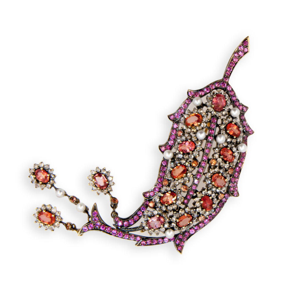 18 karat yellow gold blackened brooch Leaf design 14 oval Padparadscha color sapphires approximately 7.95 carats total weight 12 Round Padparadscha color sapphires approximately .80 carat total weight 120 Round Pink Sapphires approximately 3.95 carats total weight 168 Rose cut diamonds approximately 3.43 carats total weight and 9 Pearls approximately 3.4 mm approximately 1.87 carats total weight. Three drops at end of brooch move freely.