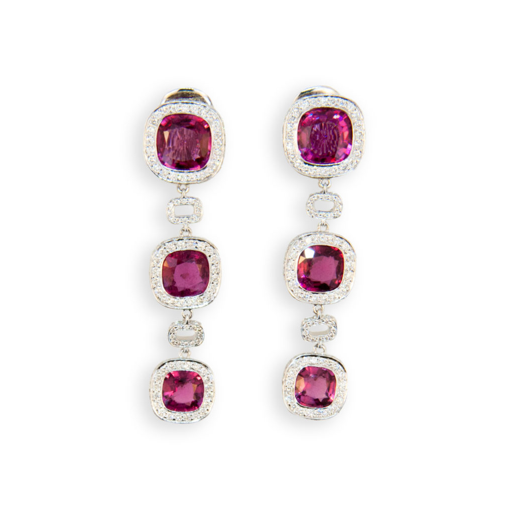 18 karat white gold earrings 9 x 9 mm Rubellite at top with two 8.5 mm and two 7.5 mm Rubellite below 11.57 carats total weight with micro set diamonds surrounding and rectangular diamond sections separating (four hundred sixty four diamonds) 3.01 carats total weight.
