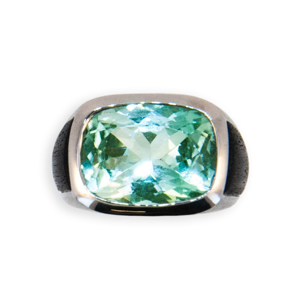 18 karat white gold ring set with one rectangular cushion cut Mint Green Tourmaline weighing 8.51 carats Set horizontal on finger. Sides of shank are inlaid with Ebony wood inserts. Size 6 1/4.