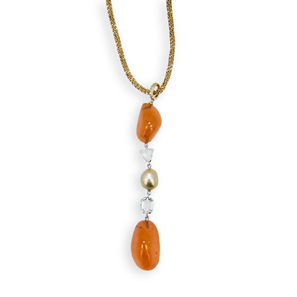 18 karat yellow and white gold necklace (2) freeform tumble polished Mandarin Garnets 53.85 carats (1) Gold Keshi Pearl .71 grams (2) Fancy shaped rose cut diamonds 1.26 carats total weight (7) round diamonds .04 carat Yellow gold Chain 16 inches long. Pendant is approximately 3 inches long.