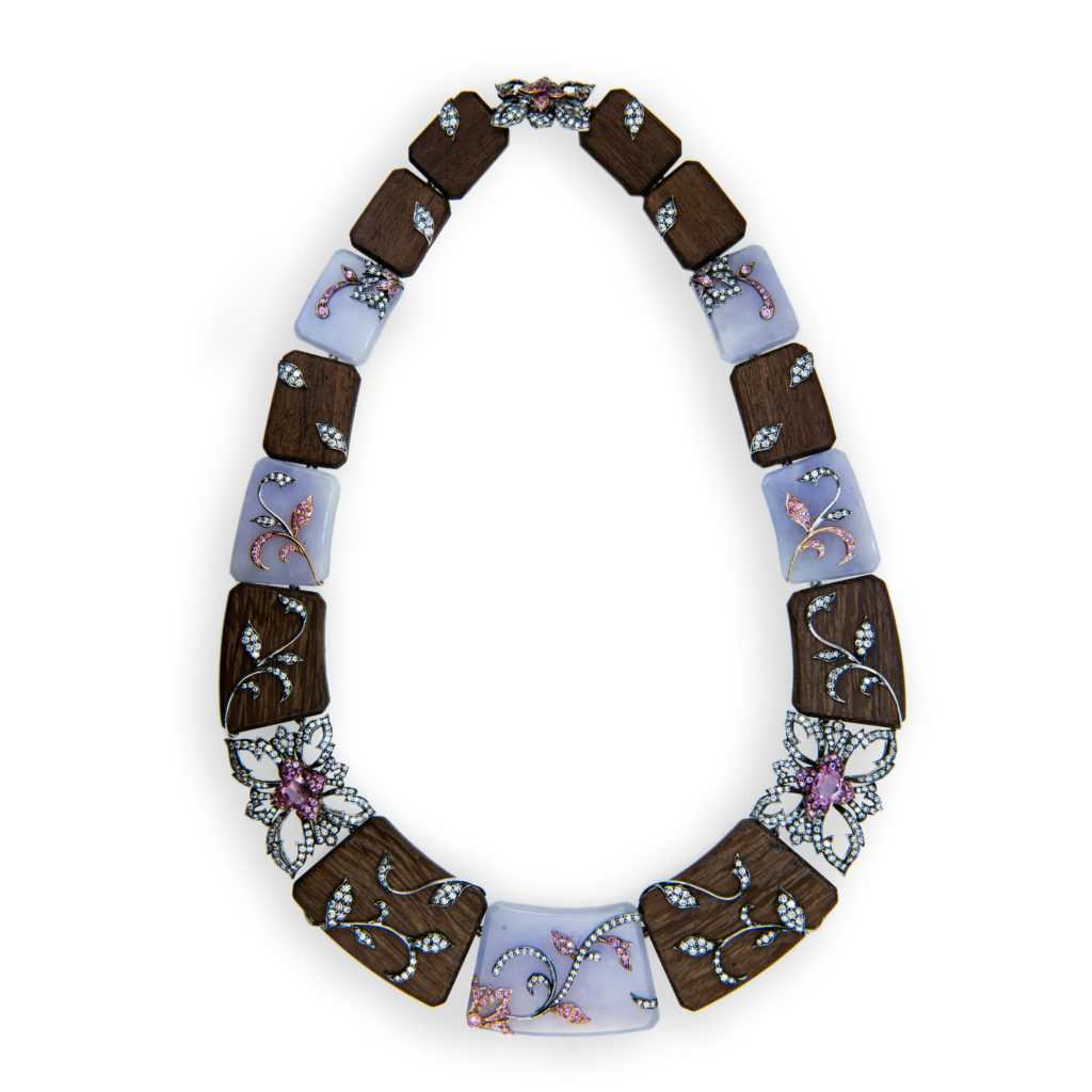18 karat blackened rose and white gold necklace (10) rectangular sections of Amaranth wood, (5) rectangular sections of Lavender Jade two gold, pink sapphire and diamond sections and one gold, diamond and pink sapphire clasp section. Two gold sections are each set with one oval pink sapphire round pink sapphires and diamonds. Wood and Jade sections have raised gold designs set with diamonds and pink sapphires. 158 total pink sapphires (including two ovals) 1.84 carats total weight and 527 diamonds 5.12 carats total weight.