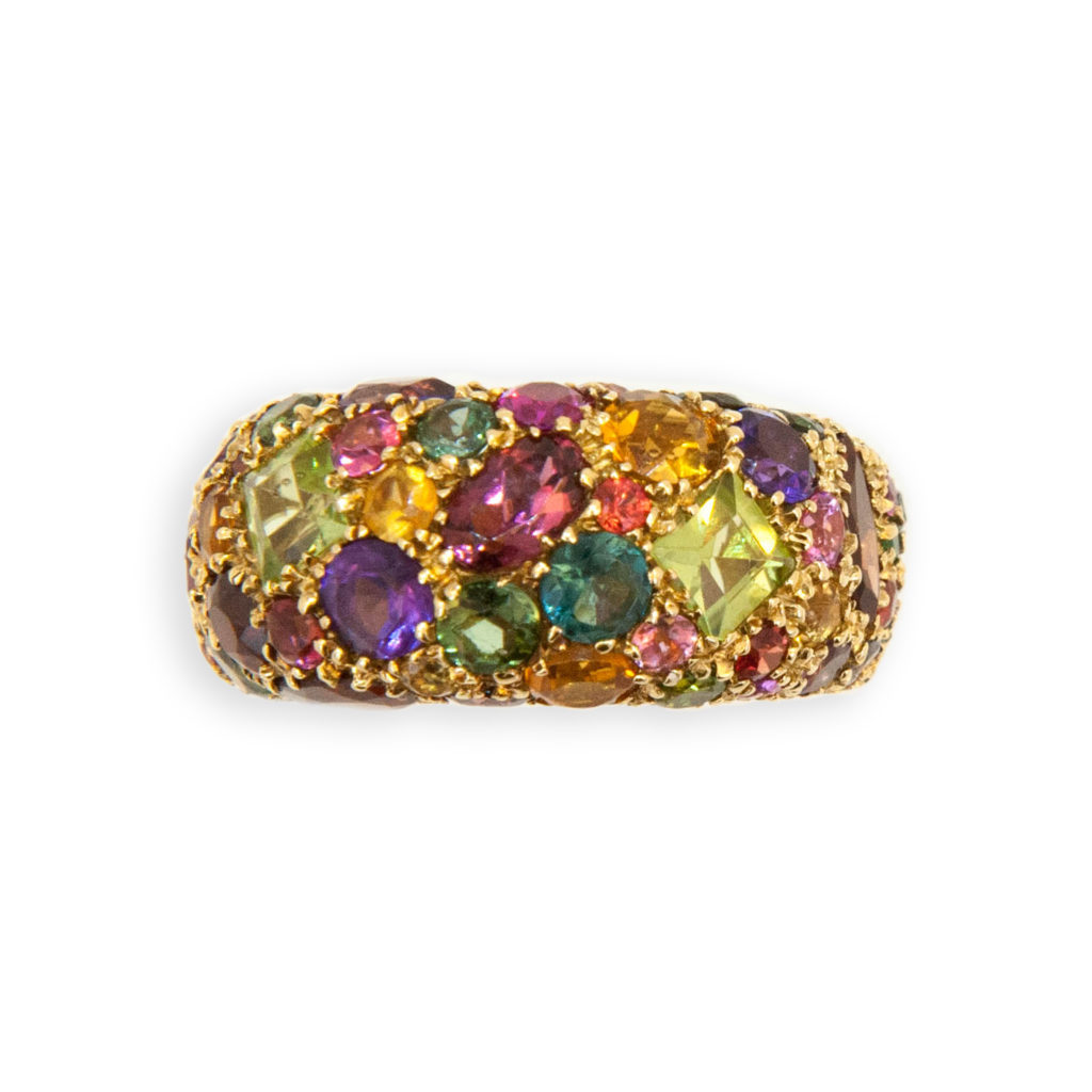 18 karat yellow gold Kaleidoscope ring set with 5.66 carats of assorted semi-precious stones. Peridot, garnet, amethyst, tourmaline, citrine etc. Ring size 6.75.