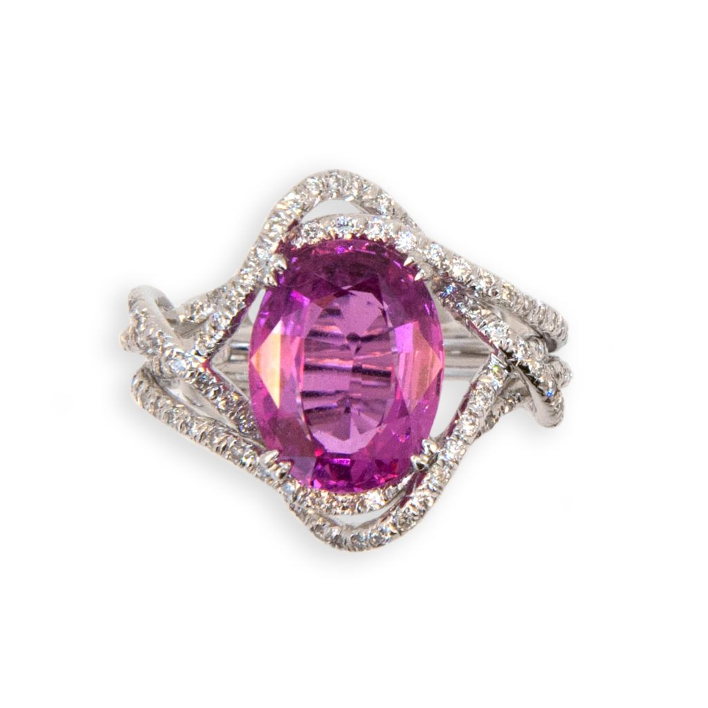 18 karat white gold ring micro-set diamond twisted ribbon like 1.5 mm mounting set with an oval Pink Sapphire 5.28 carats and 159 Diamonds .84 carat total weight. Ring size 7.5.