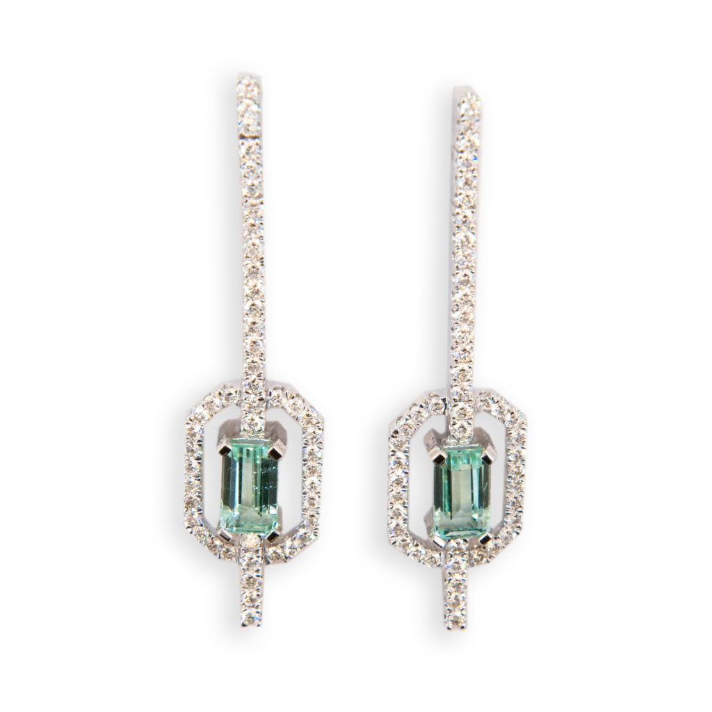 18 karat white gold earrings each set with one emerald cut Mint Green Tourmaline two are 1.58 carats total weight. Micro-set in a straight line from post and in an octagonal frame around Tourmaline are 47 Diamonds 94 total .93 carat total weight.