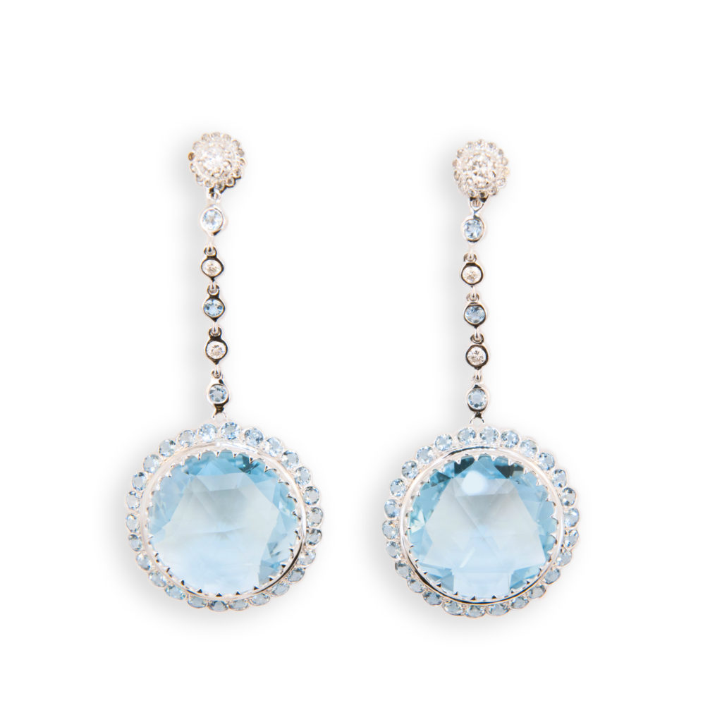 18 karat white gold Blue Topaz, diamond, and aquamarine earrings. Briolette topaz 45.00 carats, surrounded by round faceted aquamarine,,alternating diamonds and aquamarine between bottom and top of earring. Top is round set with diamonds in cluster, diamonds .78 carat, and aquamarine 3.30 carats.