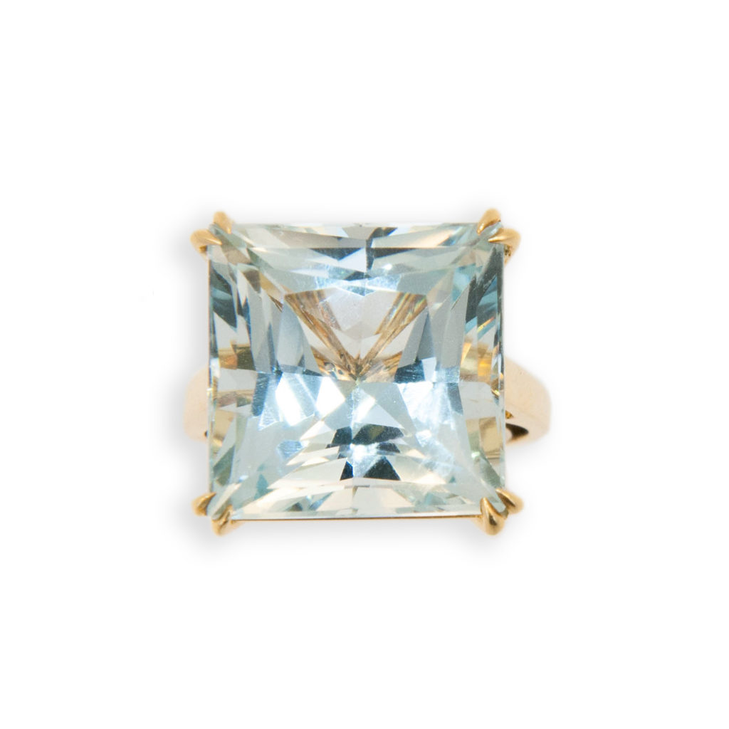 18 karat yellow gold ring set with square faceted Aquamarine 15.21 carats. Double prong on each corner.Size 6 with a horseshoe.