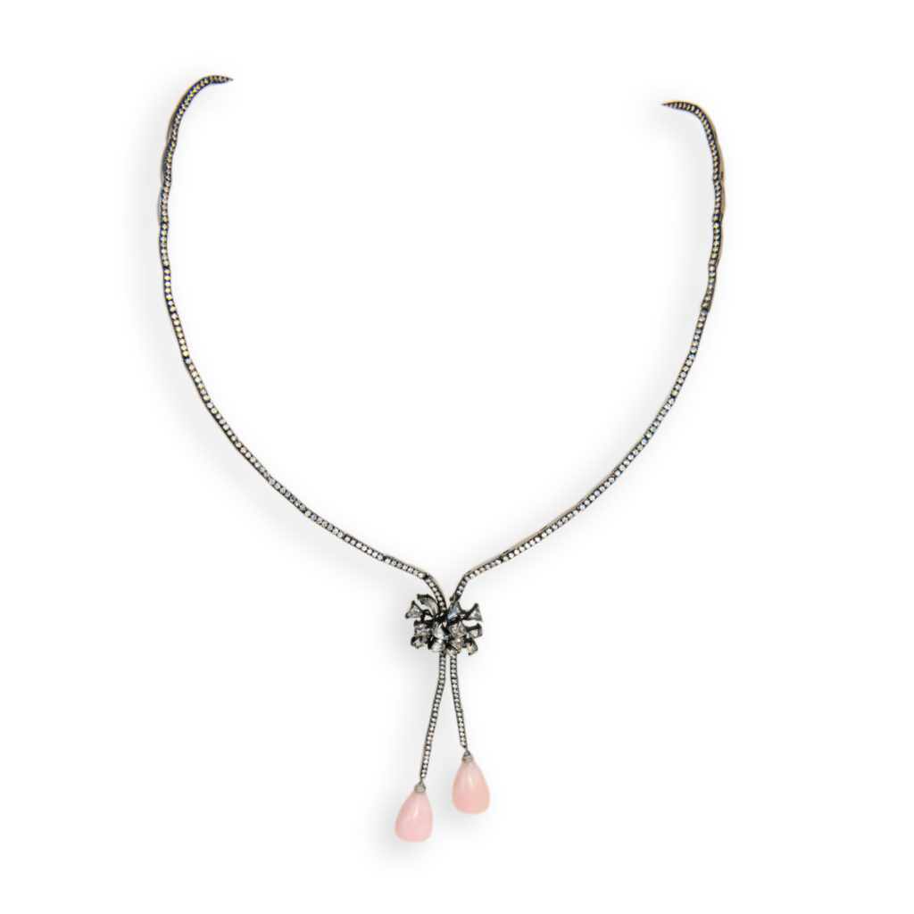 18 karat blackened white gold necklace with (2) Pink Opal drops 10.66 carats total weight, (13) fancy shaped Rose cut Diamonds in a knot shape above pink opal drops 1.44 carats total weight and 331 round Diamonds set in single line and between knot and pink opals 2.64 carats total weight. 16 inches length.
