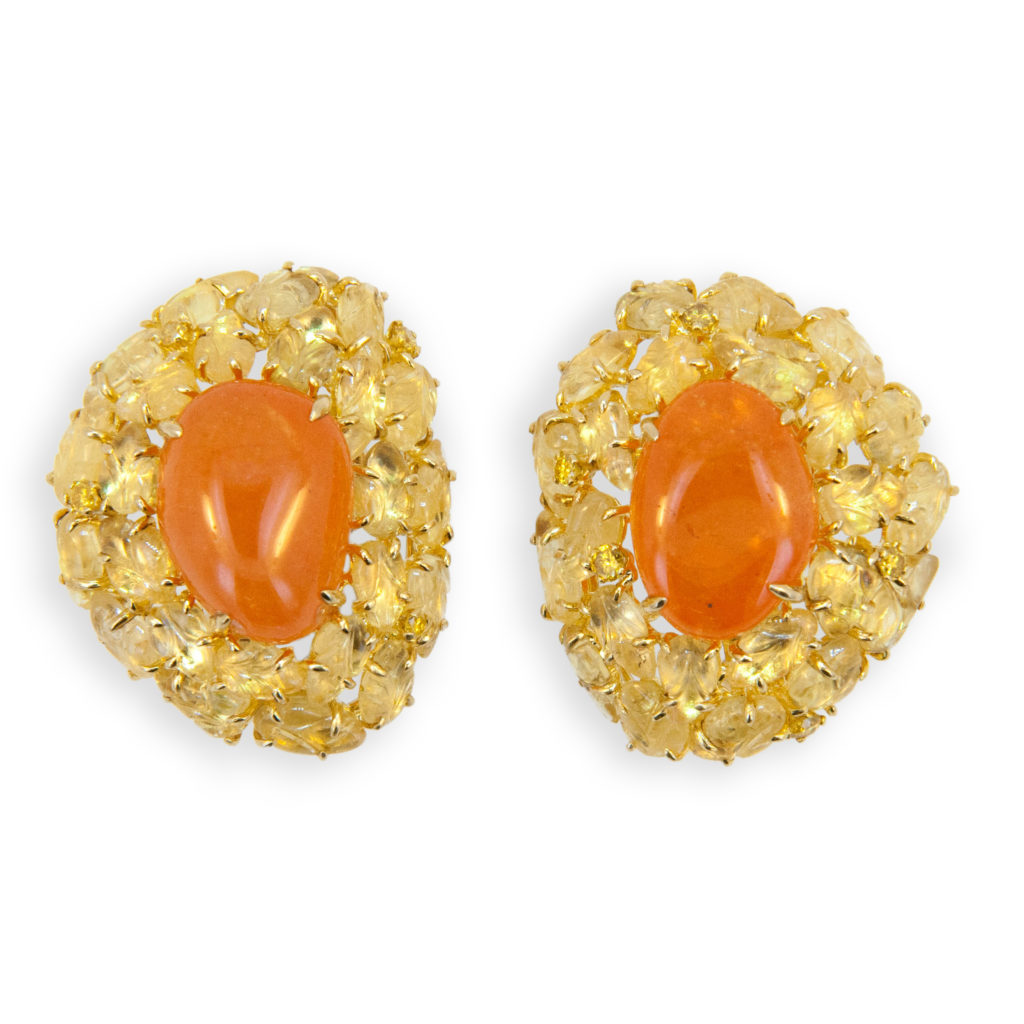 18 karat yellow gold earring (2) freeform tumble polished Mandarin Garnet 29.30 carats total weight. (47) carved yellow sapphire leaves 19.09 carats total weight and (9) yellow diamonds .30 carats total weight. Can be worn as clips or pierced.