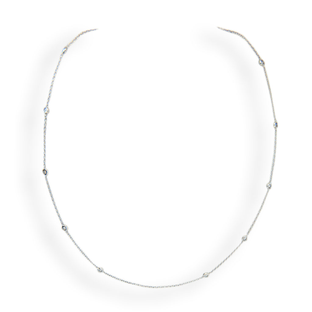18 karat white gold 17 inch cable chain with 12 diamonds spaced at 1 1/4 inch intervals with center at 2 1/2 inches apart. .74 carat total weight. Spring ring clasp.