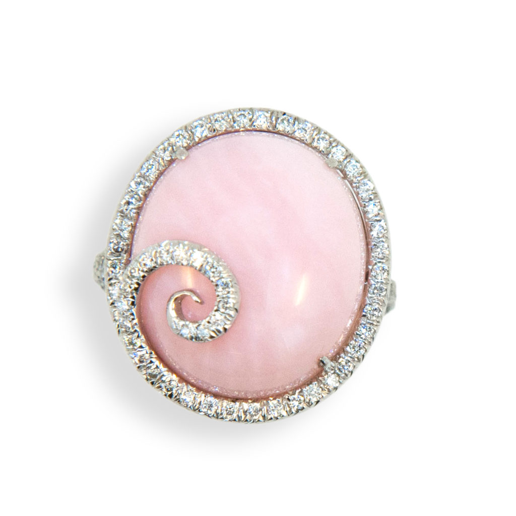 18 karat white gold ring set with oval cab Pink Opal 13.57 carats with diamond swirl on top and diamonds surrounding and down shank 185 diamonds total 1.23 carats total weight. Ring is a size 6.25 with a horseshoe.