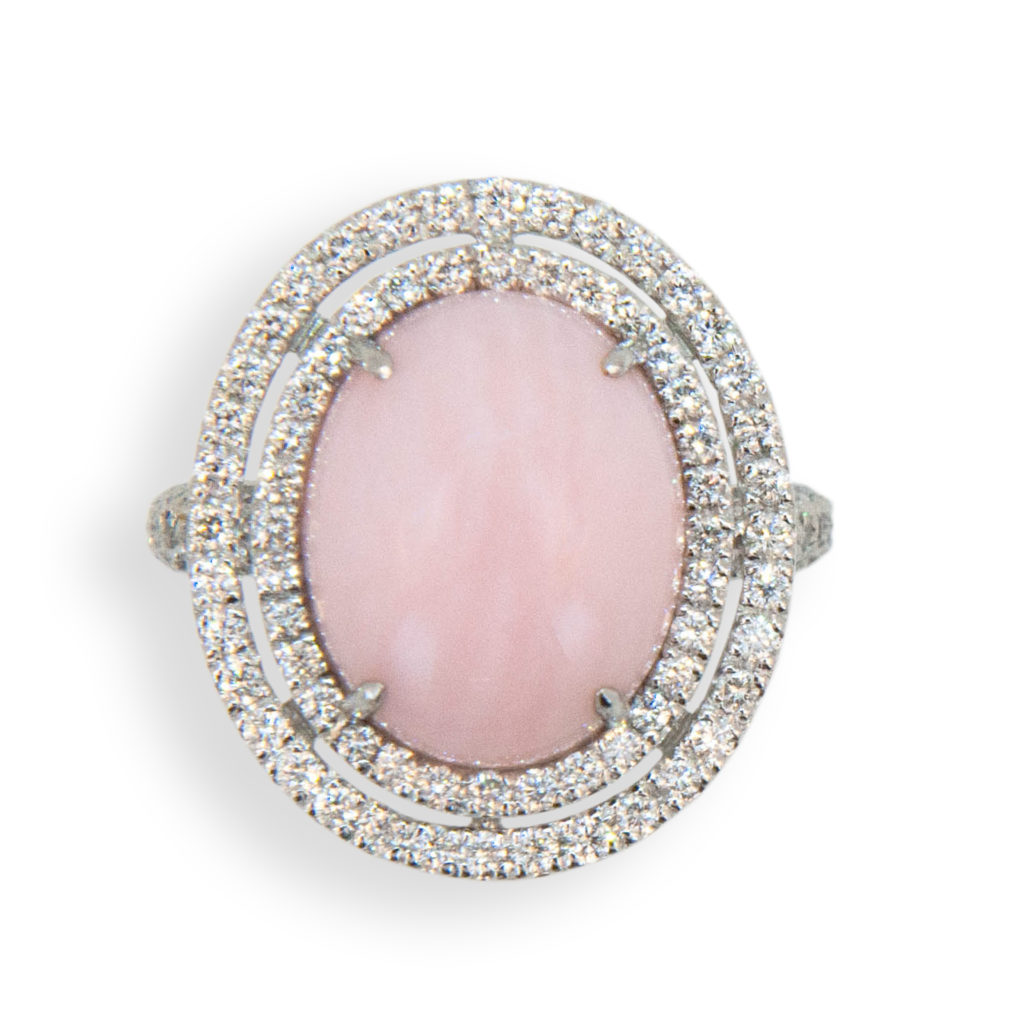 18 karat white gold ring oval cab Pink Opal 5.67 carats surrounded by two rows of diamonds two hundred diamonds equal 1.94 carats total weight. Ring size is 6 1/2