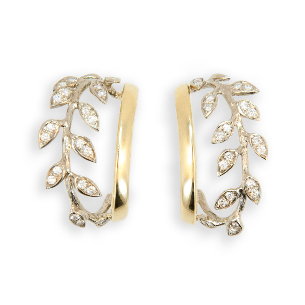 New to the Laura Munder Collection! 18 karat yellow and white gold leaf hoop earrings each set with 23 round 1.2 - 1.3 mm full cut diamonds H/SI-1 approximately .45 carat total weight.